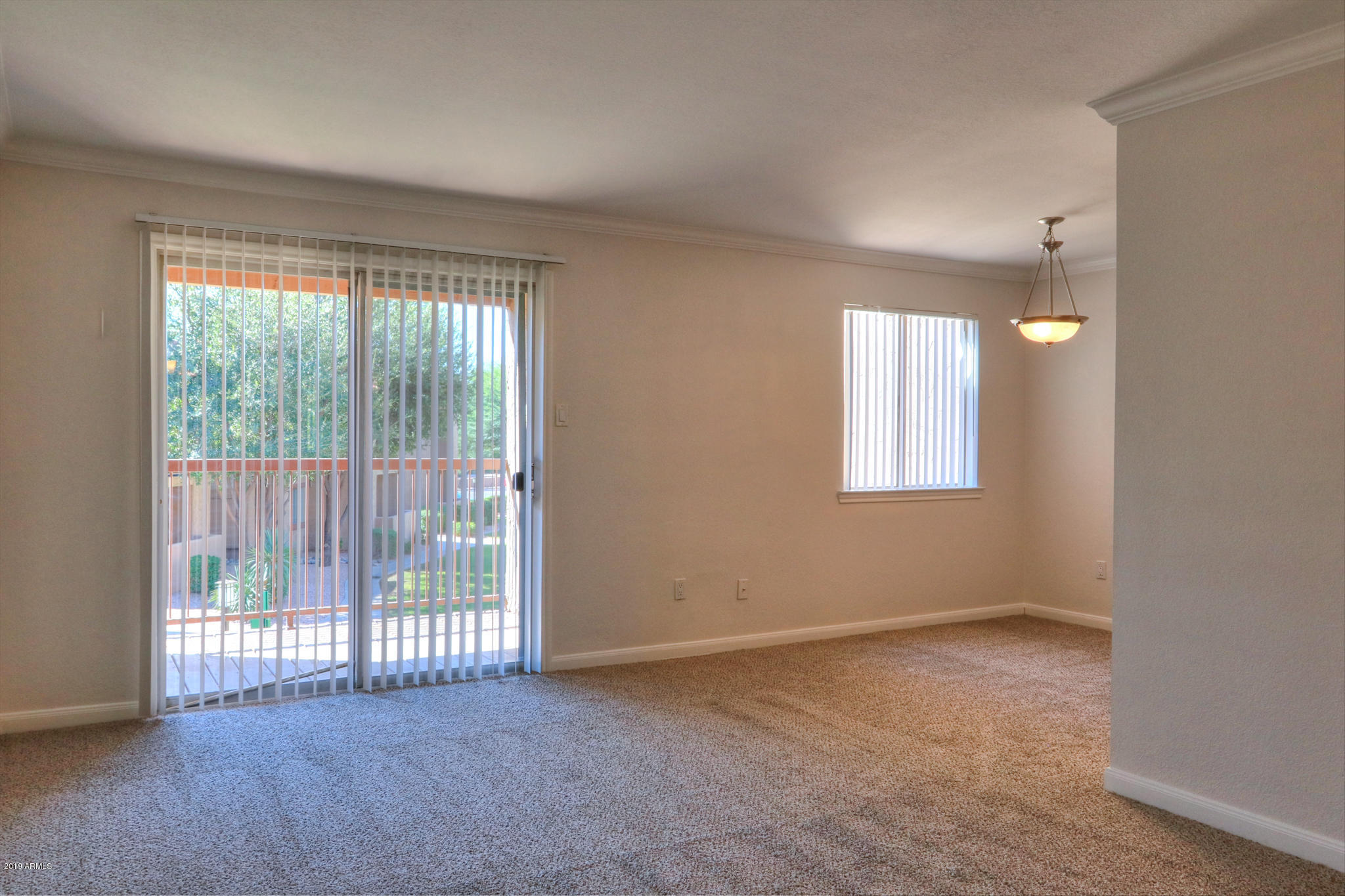 8256 East Arabian Trail, Unit 237 Scottsdale, AZ 85258 - Photo 7 of 31 a view of an empty room with wooden floor and a window
