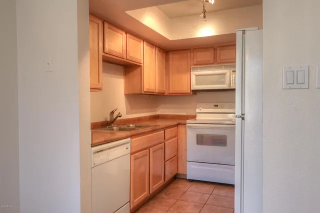 a kitchen with a stove sink and cabinets