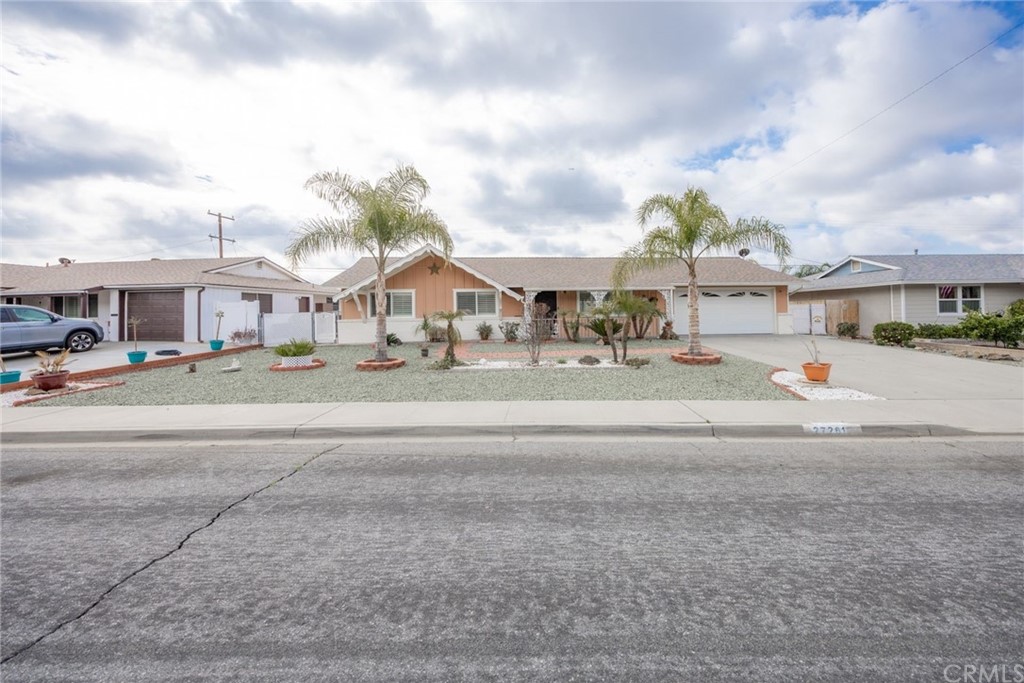 27261 El Rancho Road Menifee, CA 92586 - Photo 1 of 1 a street view with houses and car parked in the background