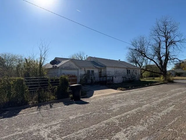 a view of a house with a yard covered in snow