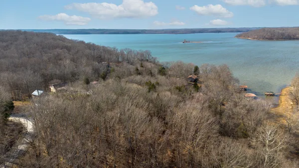 a view of a lake in middle of forest