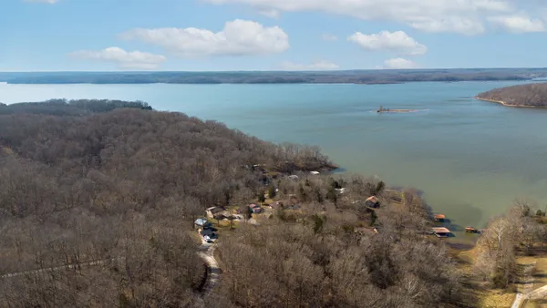 a view of a lake in middle of forest