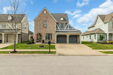 a large kitchen with stainless steel appliances granite countertop a lot of counter space and wooden floors