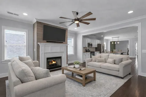 a living room with furniture fireplace and flat screen tv