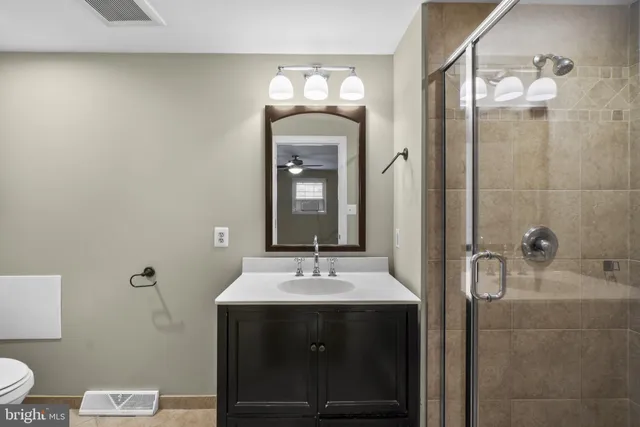 a bathroom with a sink a toilet and a mirror