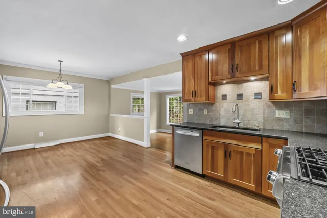 a kitchen with stainless steel appliances granite countertop a stove and cabinets