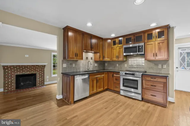 a kitchen with stainless steel appliances granite countertop a stove sink and cabinets