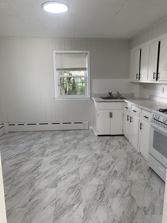 86 Hunter Street, Unit 2N Fall River, MA 02721 - Photo 1 of 4 a room with a stove a sink and a window