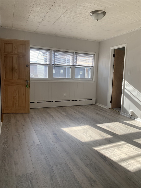 86 Hunter Street, Unit 2N Fall River, MA 02721 - Photo 2 of 4 an empty room with wooden floor and windows