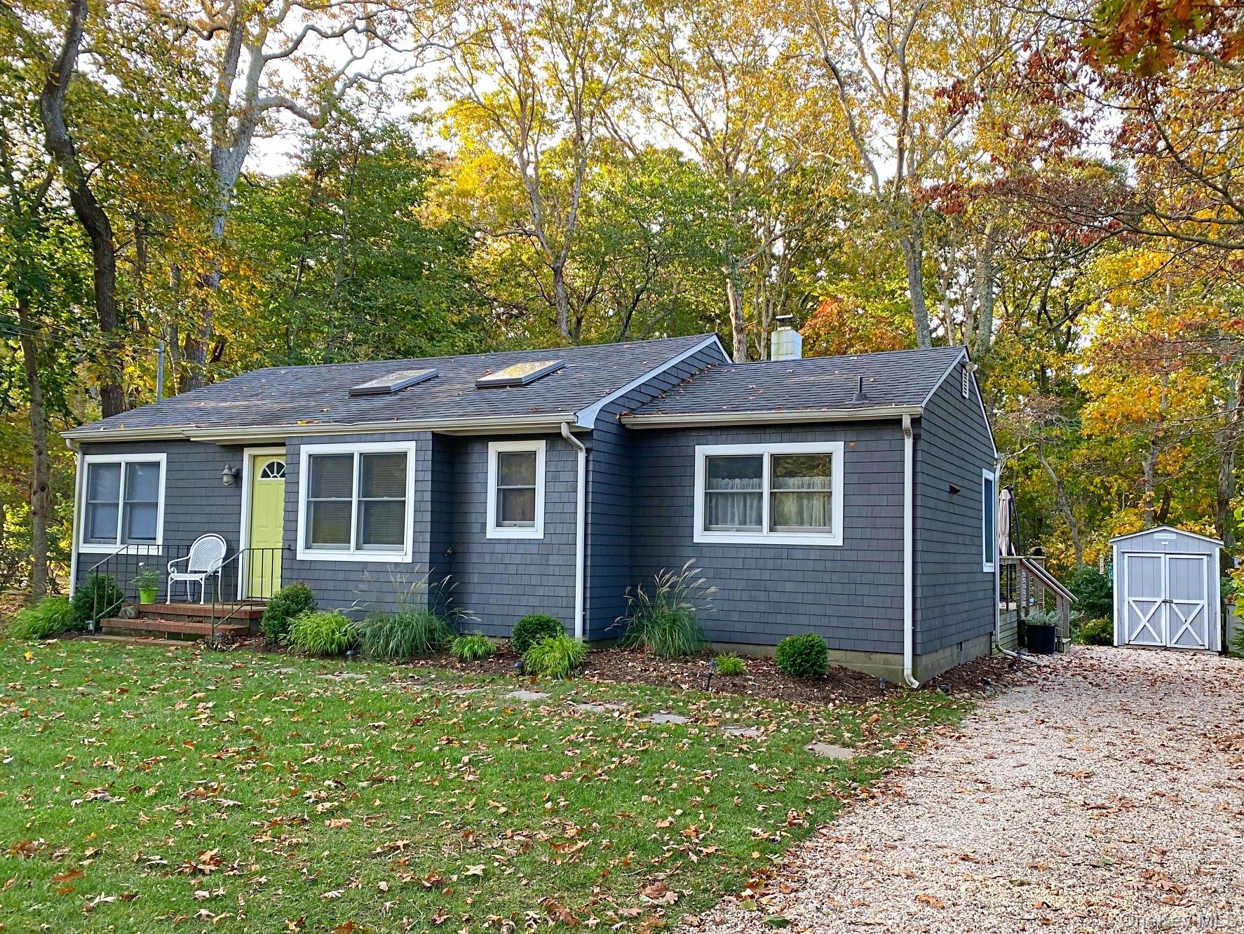 1855 Kenneys Road Southold, NY 11971 - Photo 16 of 18 a front view of a house with garden