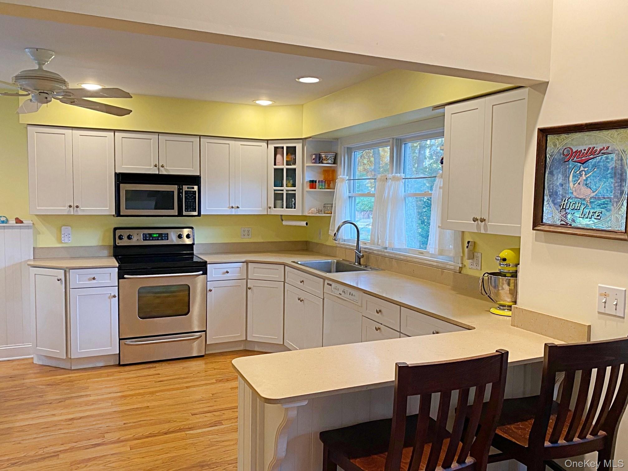 1855 Kenneys Road Southold, NY 11971 - Photo 4 of 18 a kitchen with a stove a sink and a microwave