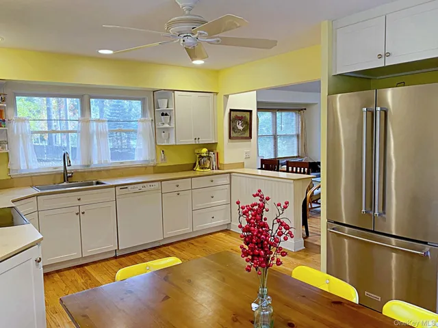 a kitchen with stainless steel appliances granite countertop a refrigerator sink and cabinets