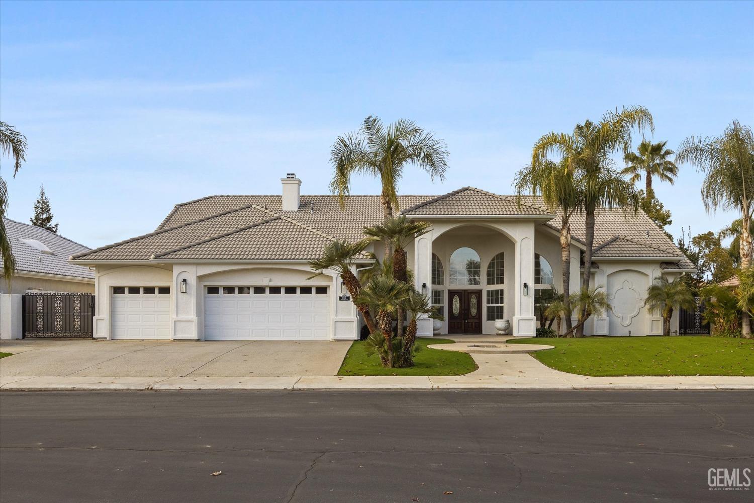 a front view of a house with a garden and a yard