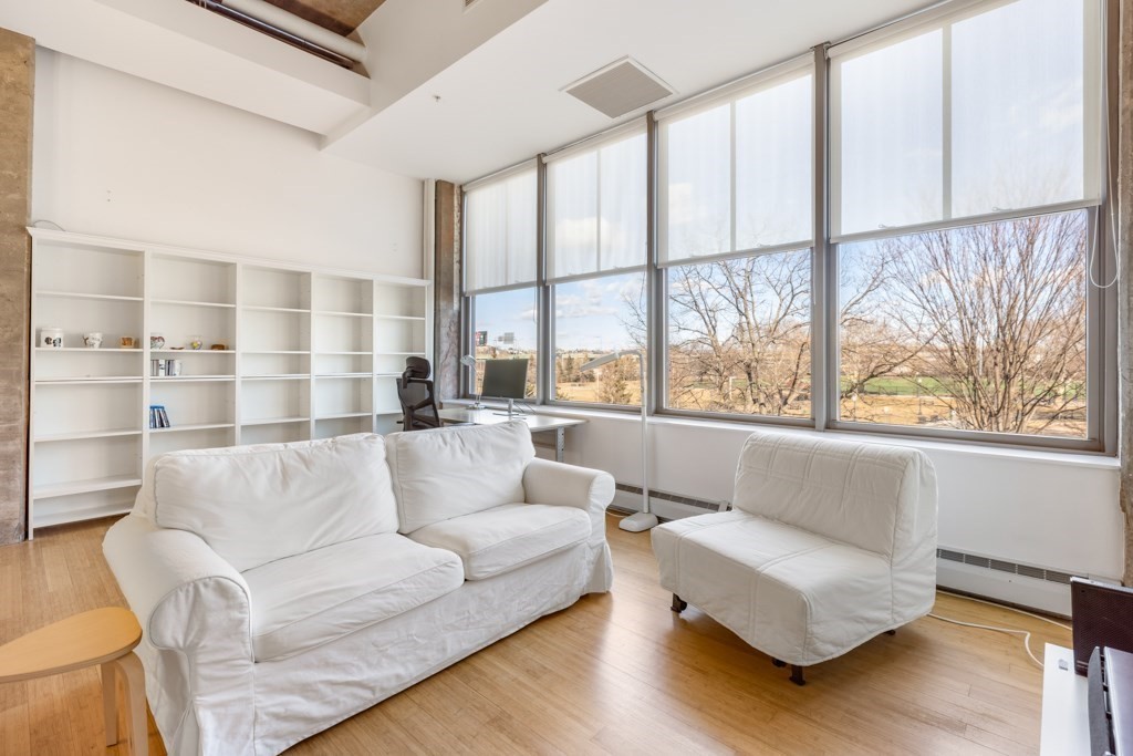 a living room with furniture and a large window