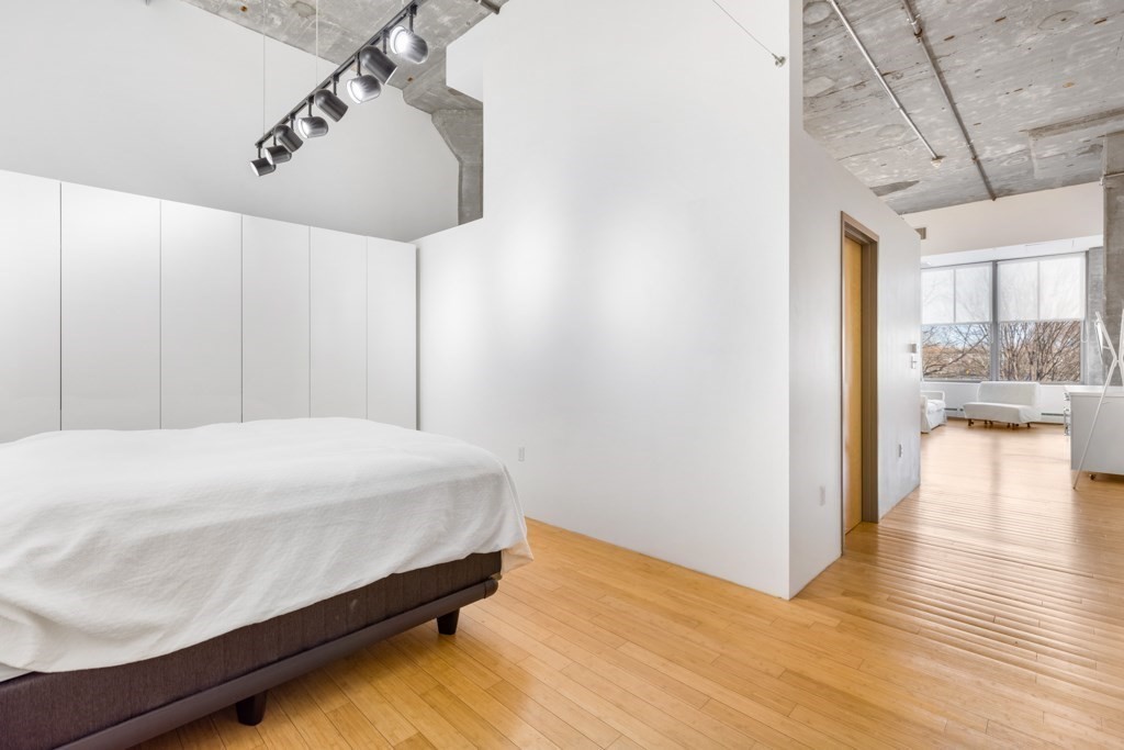 156 Porter Street, Unit 249 Boston, MA 02128 - Photo 12 of 30 a bedroom with a bed and a walk in closet