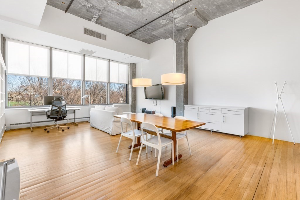 156 Porter Street, Unit 249 Boston, MA 02128 - Photo 3 of 30 a living room with furniture and a wooden floor