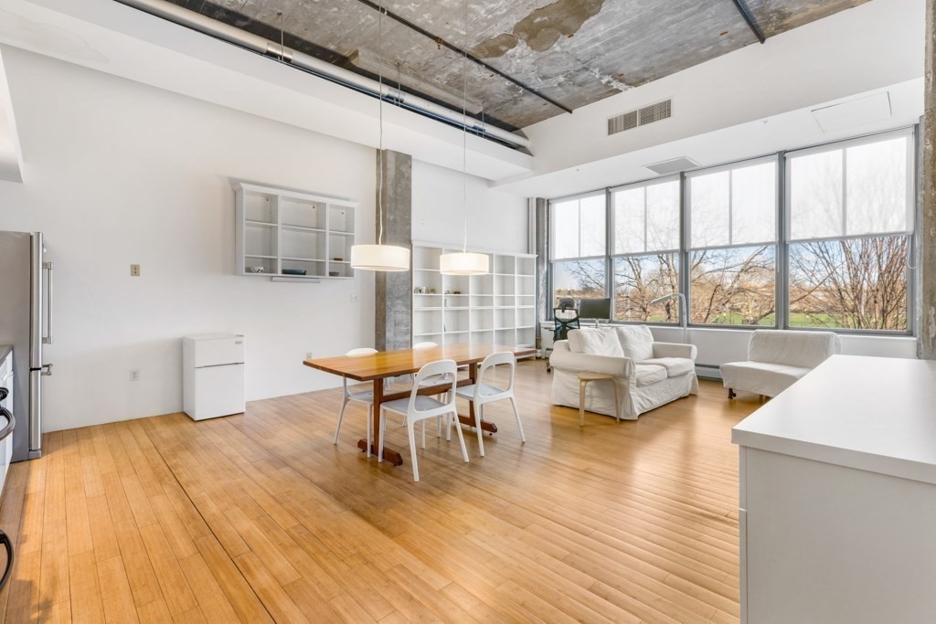 156 Porter Street, Unit 249 Boston, MA 02128 - Photo 4 of 30 a living room with fireplace furniture and a large window