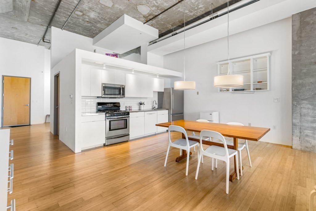 156 Porter Street, Unit 249 Boston, MA 02128 - Photo 5 of 30 a view of a dining room with furniture and wooden floor