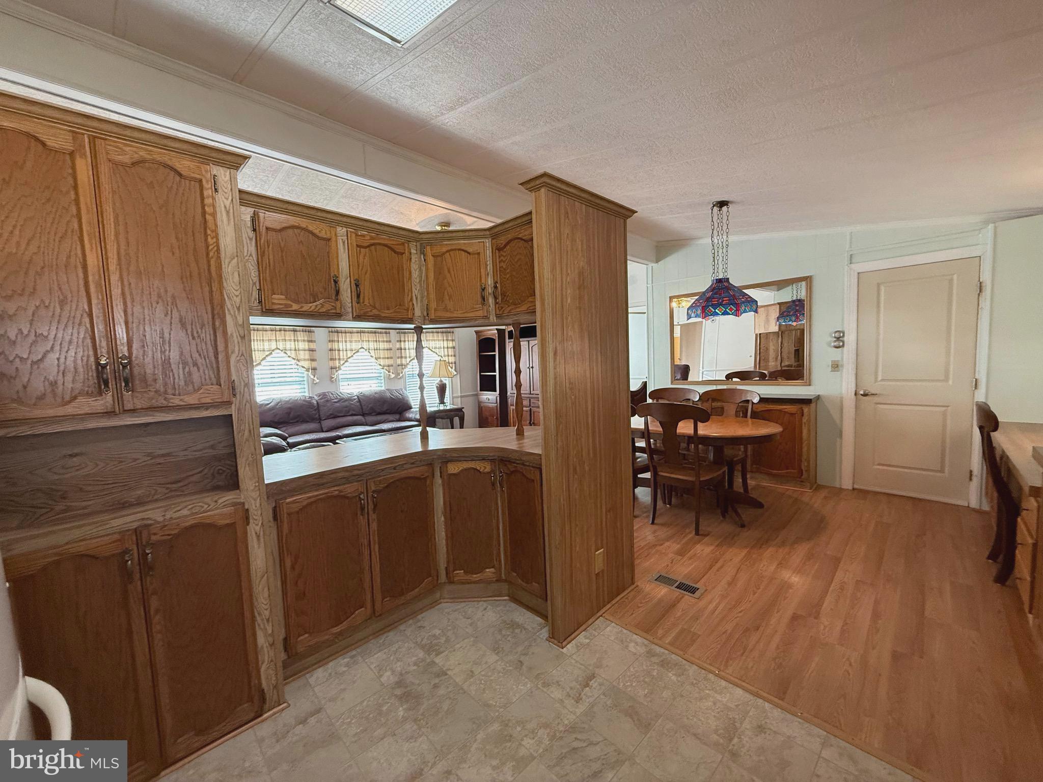 386 Indian Way Buena, NJ 08310 - Photo 8 of 53 a kitchen with stainless steel appliances kitchen island granite countertop a refrigerator and a sink