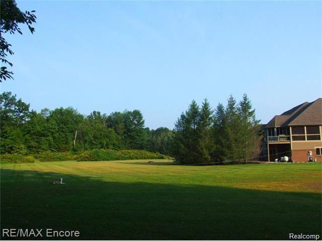 8629 Sashabaw Road Clarkston, MI 48348 - Photo 32 of 34 Side view of home with screened balcony and private pool area