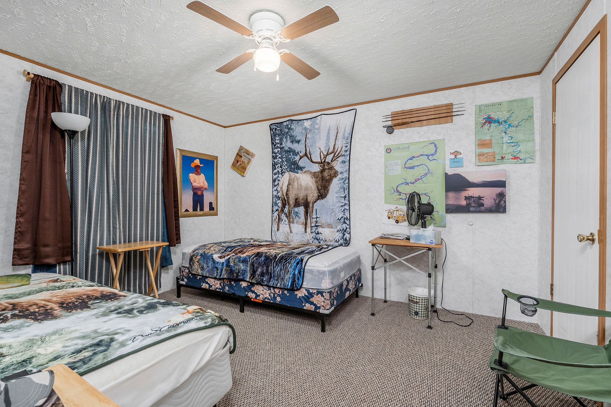 43 Moss Bend Road Lancaster, TN 38569 - Photo 25 of 75 a bedroom with a bed and a chandelier