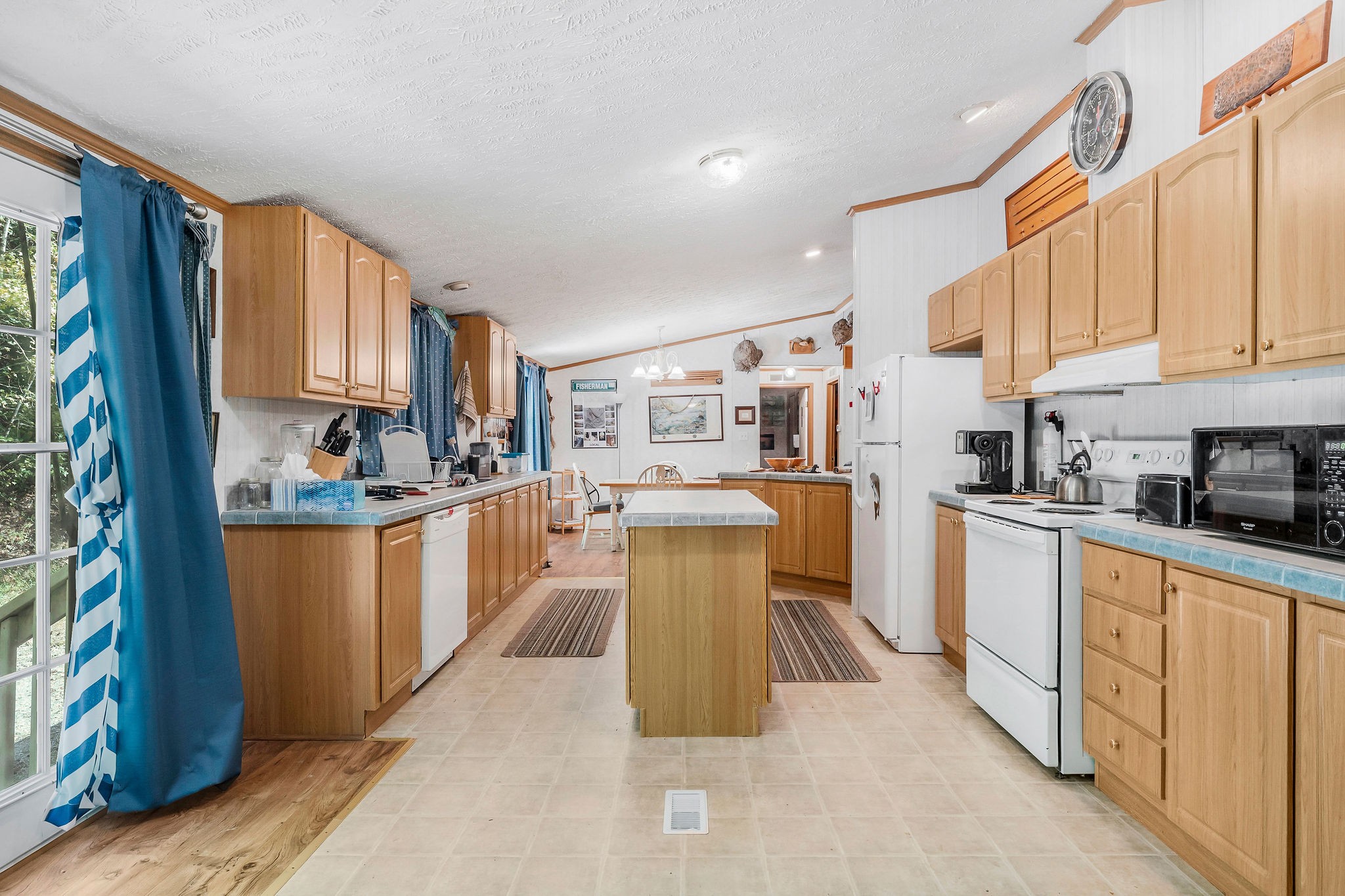 43 Moss Bend Road Lancaster, TN 38569 - Photo 31 of 75 a kitchen with stainless steel appliances granite countertop a refrigerator a sink dishwasher a stove top oven a dining table and chairs with wooden floor