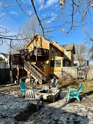 a view of a chair and tables in backyard