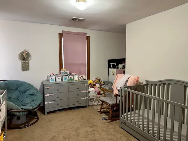 a bed room with furniture and a window