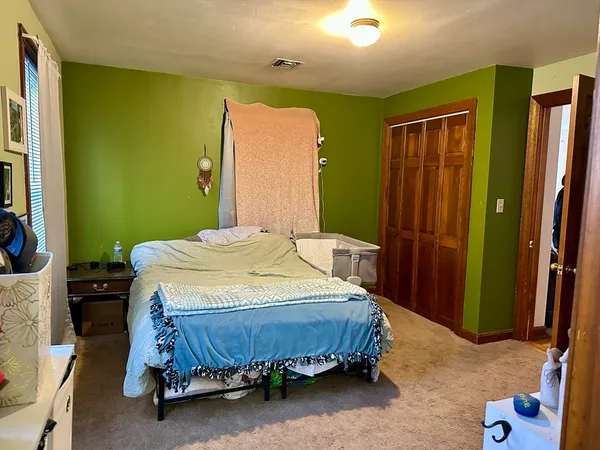 a bedroom with a bed and a mirror