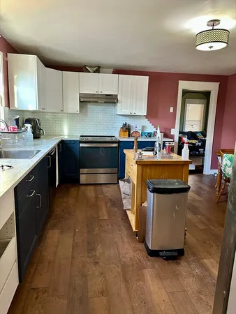 a kitchen with stainless steel appliances granite countertop a stove a sink dishwasher and a refrigerator