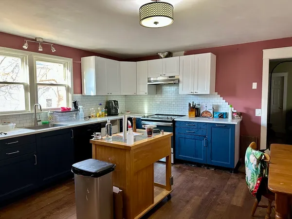 a kitchen with granite countertop a sink appliances and cabinets