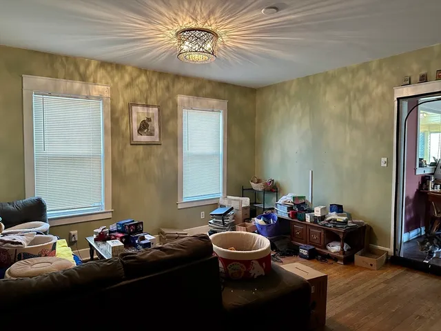 a living room with furniture and a mirror
