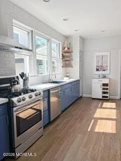 a kitchen with stainless steel appliances granite countertop a stove a sink and a refrigerator