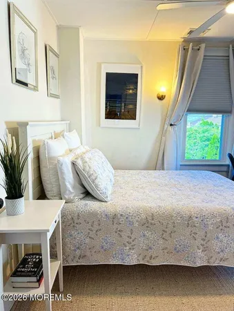 a bedroom with a bed and a potted plant