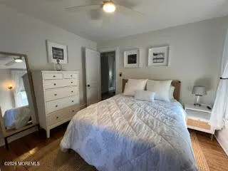 a bedroom with a bed and a mirror