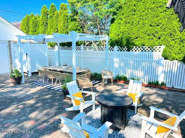 a view of a chairs and table in backyard