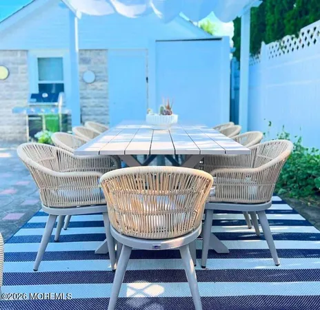 a view of a chairs with barbeque grill wooden floor and fence