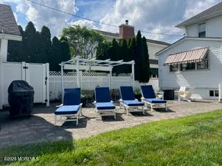 a building outdoor space with patio furniture and a fireplace