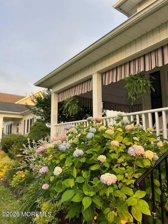 a view of a house with a flower garden