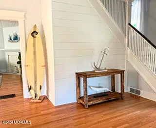 a view of an entryway with wooden floor
