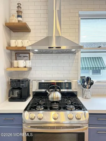 a stove top oven sitting inside of a kitchen