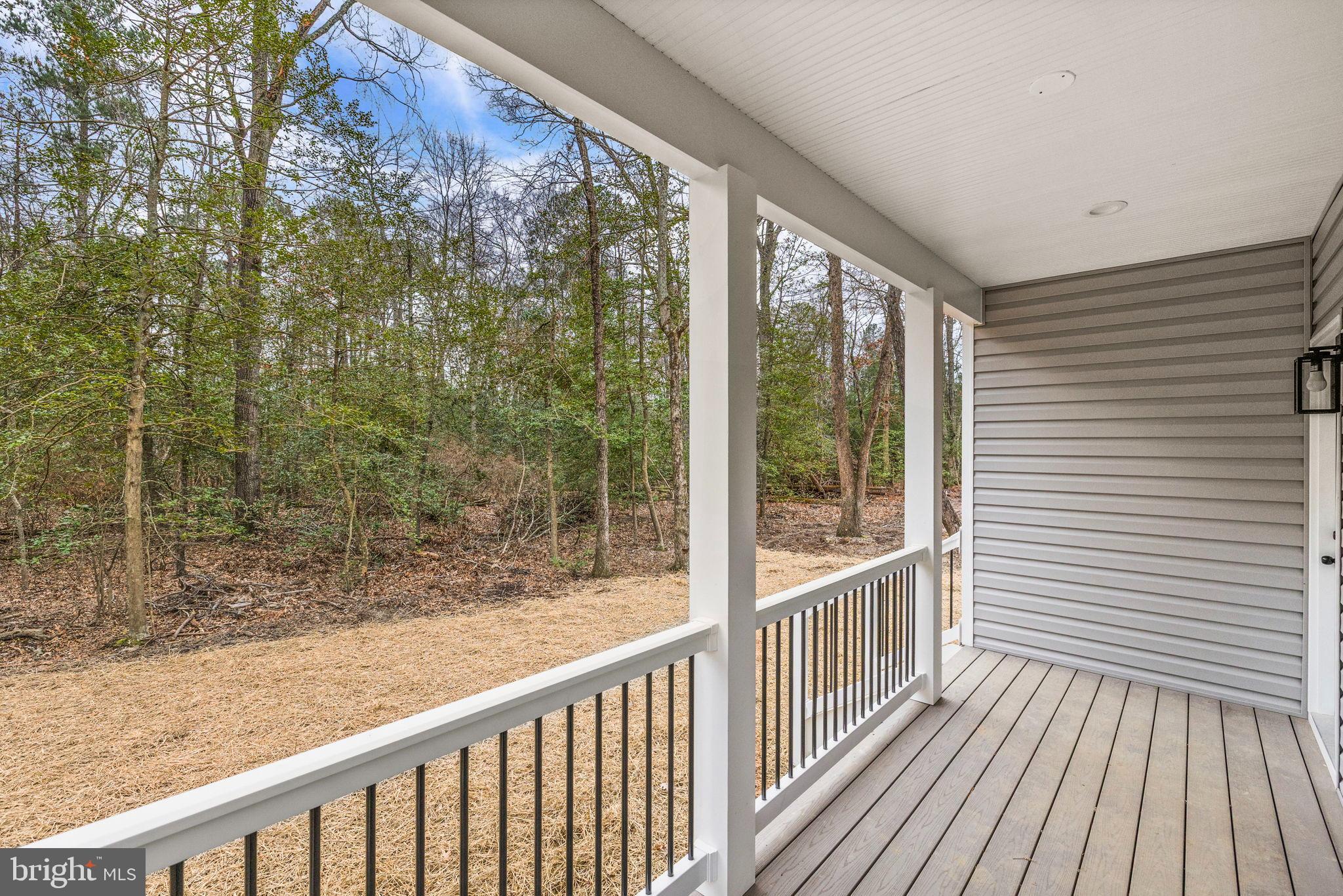 312 9th Street Colonial Beach, VA 22443 - Photo 27 of 62 Serene porch overlooking lush greenery.
