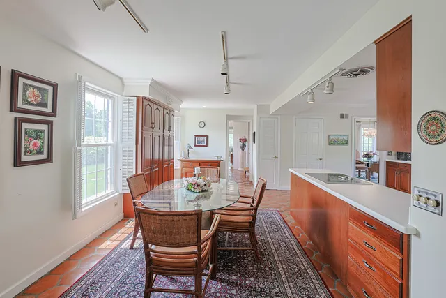 a dining room with furniture a rug and wooden floor