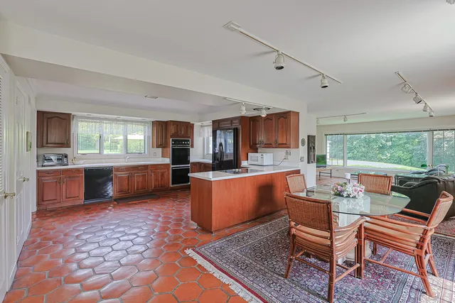 a large living room with a couch and a dining table