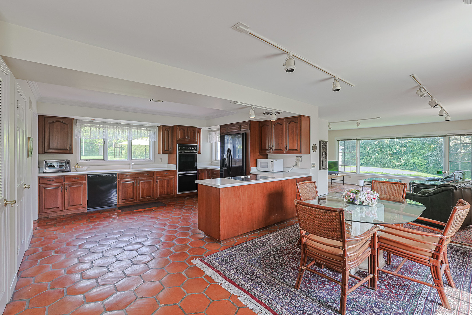 1596 West Palatine Road Inverness, IL 60067 - Photo 14 of 49 a large living room with a couch and a dining table