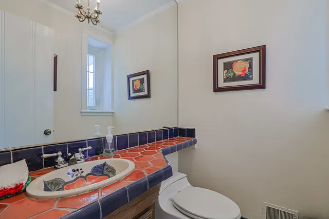 a bathroom with a sink mirror and toilet