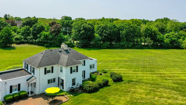 an aerial view of a house with a swimming pool outdoor seating and yard