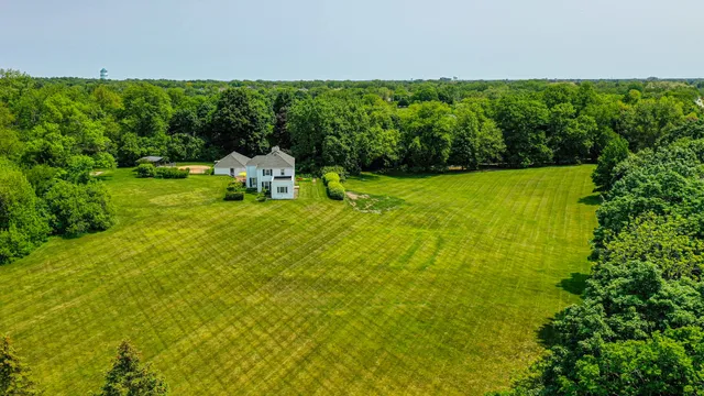 a view of a green field with trees
