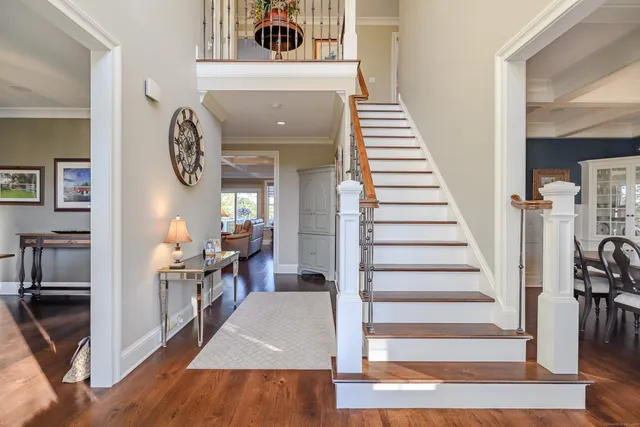 a view of entryway and hall with wooden floor