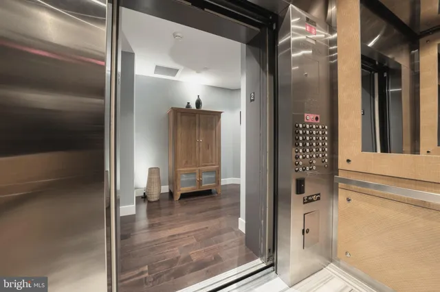 a living room with furniture and floor to ceiling windows